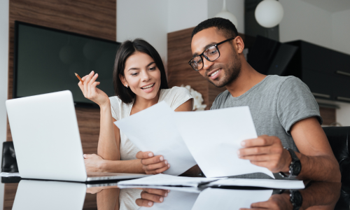 A couple discussing financing options in their home.